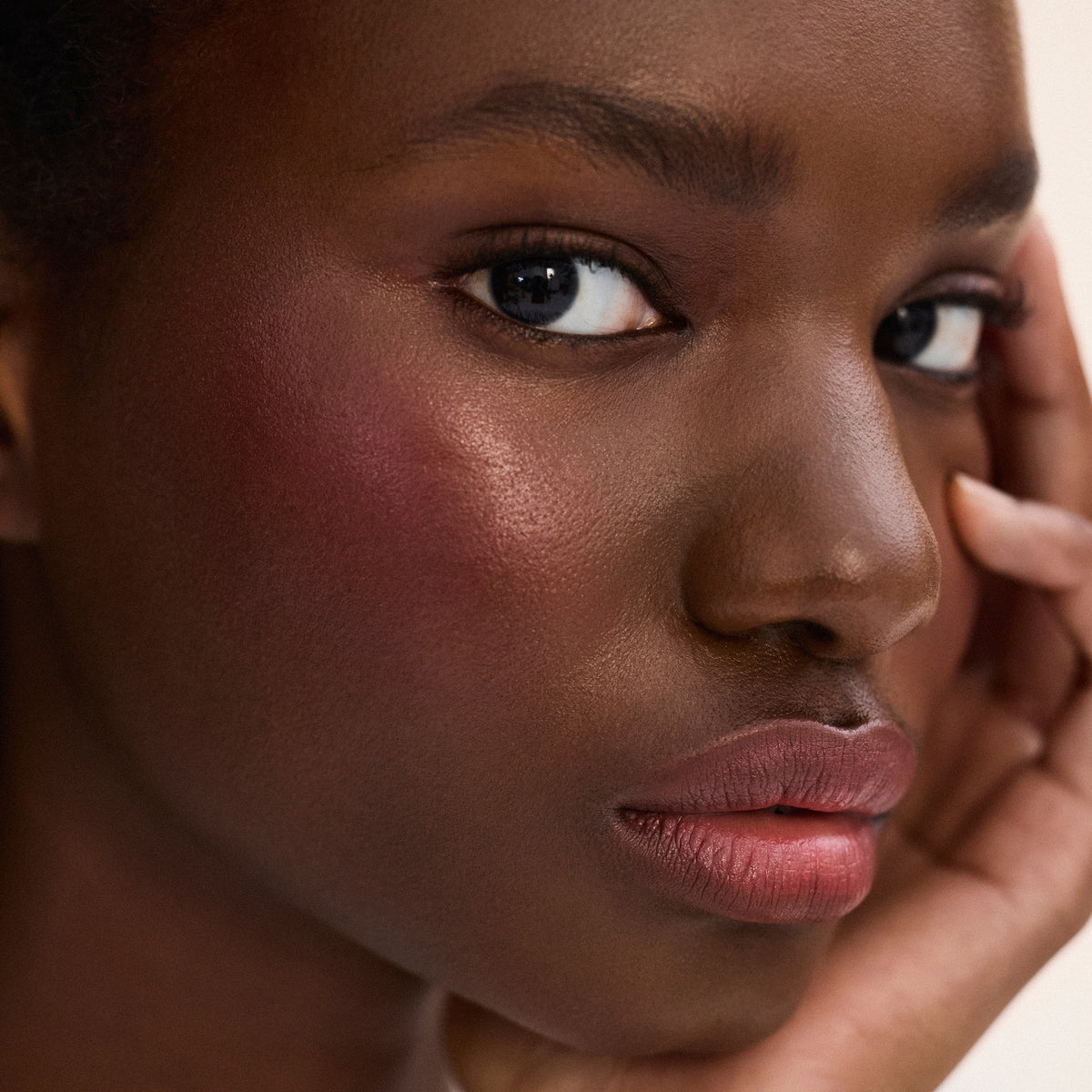 Deep skin tone model wearing Impressionist Multistick in Vibration