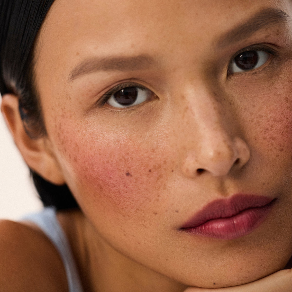 Medium skin tone model wearing Impressionist Multistick in Ripe